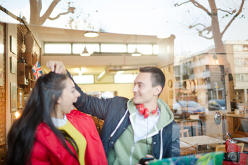 Young couple using laptop in cafe