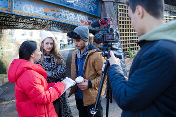 Portrait happy young adult friends vlogging outdoors