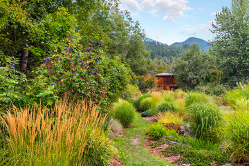 A remote log home with landscaped garden in the rural mountains of British Columbia, near Slocan Lake in New Denver, Canada.