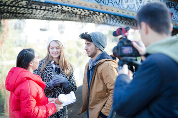 Young adults vlogging under urban bridge