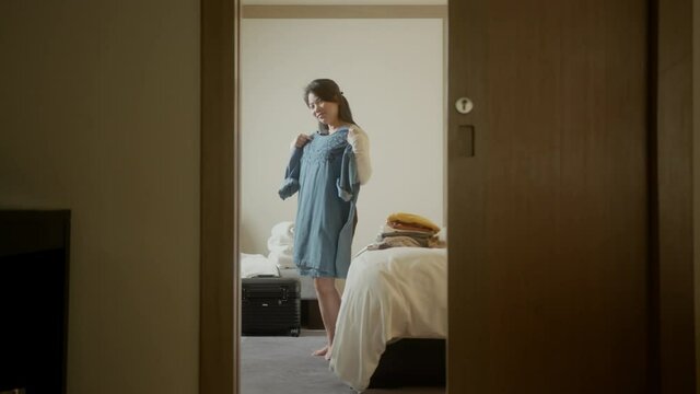 happiness asian female traveller woman enjoy happiness fitting costume cloth for vacation travel trip in bedroom at hotel relax and casual feeling,safety travel ideas concept
