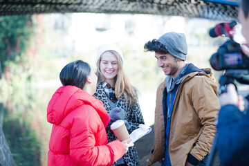 Young adults vlogging under urban bridge