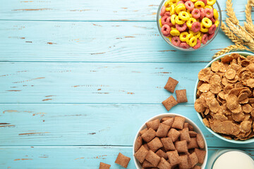 Variety of cereals in blue bowls, quick breakfast on blue wooden background. Vertical photo © Mouse family