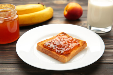Sweet toasts with jam with milk for breakfast on grey table