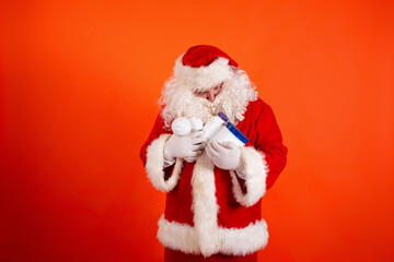 Cute toast santa claus with dumbbells in his hands on an orange background. Sports nutrition and exercise for weight loss.
