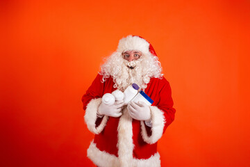 Cute toast santa claus with dumbbells in his hands on an orange background. Sports nutrition and exercise for weight loss.