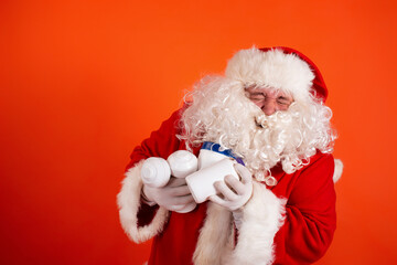 Cute toast santa claus with dumbbells in his hands on an orange background. Sports nutrition and exercise for weight loss.