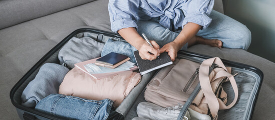 Travel. Online travel plans with Covid passport and Covid test. Traveling after quarantine, lockdown, covid 19. Staycation.local travel new normal.Girl packs baggage in suitcase and travel documents