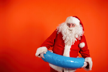 Cool santa claus with a rubber ring on an orange background.