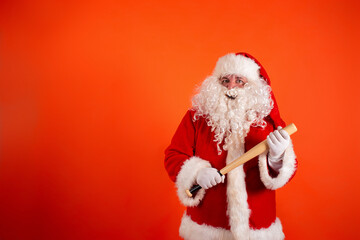 Angry Santa Claus with a baseball bat on an orange background.