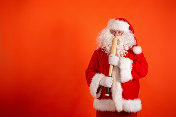 Angry Santa Claus with a baseball bat on an orange background.