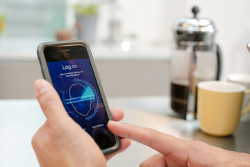 Man logging on to smart phone with face recognition