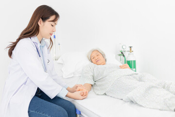 female doctor use hand screening vital sign of old asian patient , healthcare worker treatment patient in hospital, elderly health check up , palliative care