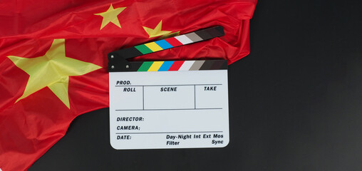 China flag and clapperboard onblack background.