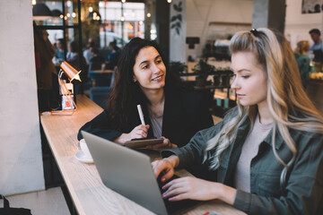 Young female workers doing project together