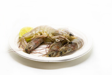 gray tiger prawns on a plate fresh seafood with lemon wedge