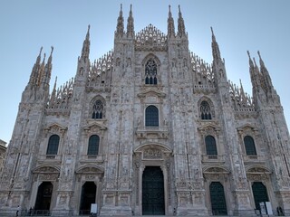 Fototapeta premium Facade of the Duomo di Milano (The Milan Cathedral) church. Famous Milan sightseeing and tourism place. Milan, Lombardy, Italy