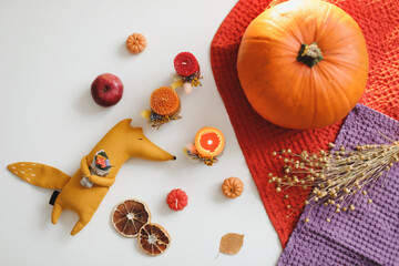 cozy autumn composition with a funny handmade toy fox, fall home decoration