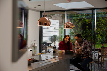 Fototapeta na wymiar Couple financial planning at digital tablet in kitchen