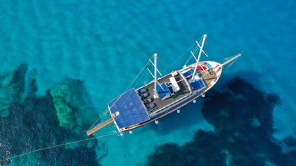 Aerial drone photo of beautiful catamaran sailing yacht anchored in tropical exotic turquoise sea...