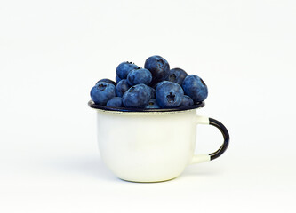 Blueberry in small white cup on white background