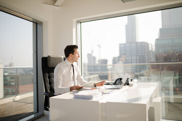 Businessman working at desk in modern office