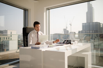 Businessman working at desk in modern office