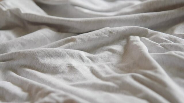 Light grey melange coloured cotton fabric close-up shot.