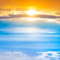 Sunset sky with sun rays and sunset clouds