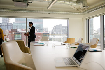 Business people leaving conference room after meeting