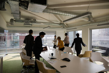 Business people leaving conference room after meeting