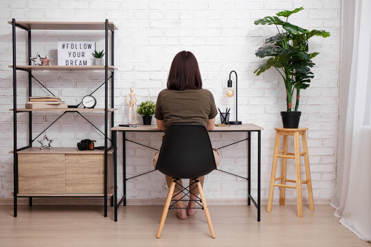 Back View Of Woman Sitting In Office Or Home