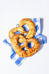 Oktoberfest concept - pretzels on a traditional napkin isolated on white background