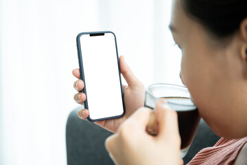 Mockup smartphone with isolated blank screen. Young Asian woman texting.
