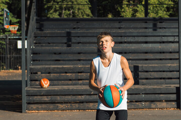 Teenager boy basketball player dribbling on sports ground