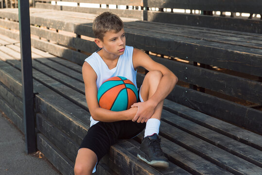 Teenage Boy Sitting On Bench Holding Ball, Basketball Player Teenager