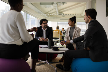 Business people discussing paperwork in relax zone