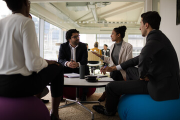 Business people discussing paperwork in relax zone