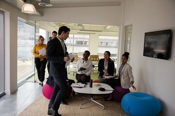 Fototapeta premium Business people discussing paperwork in relax zone