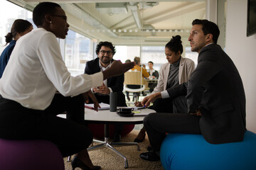 Business people discussing paperwork in relax zone