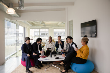 Business people discussing paperwork in relax zone