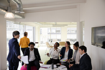 Business people discussing paperwork in relax zone