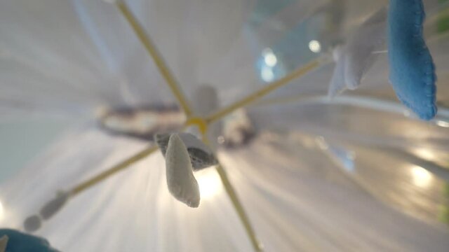 Handmade baby mobile toy hanging spinning above the crib in the bedroom.