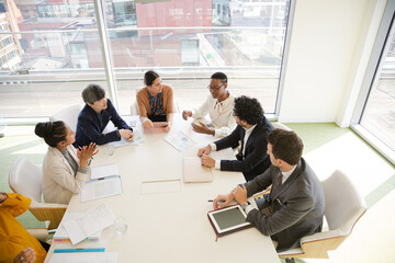 Business people discussing paperwork in conference room