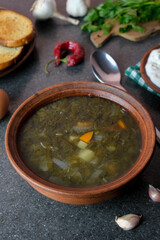 Green soup
from sorrel, nettle and spinach in a bowl, spoon, bread, pepper.