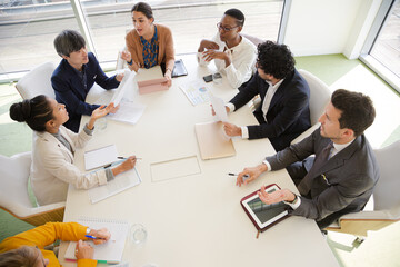 Business people discussing paperwork in conference room