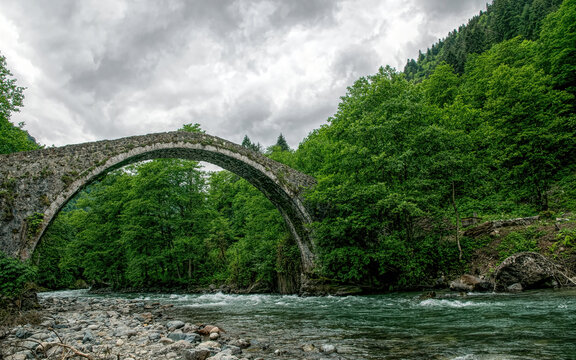 Ancient stone Turkish bridge and mountain river	