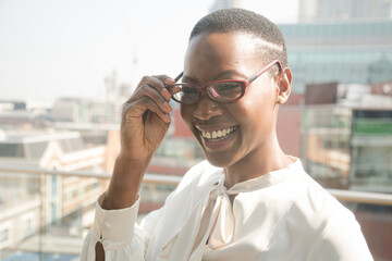 Portrait of businesswoman enjoying view from balcony