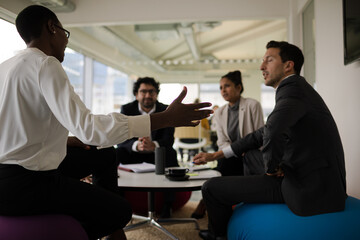 Business people discussing paperwork in relax zone