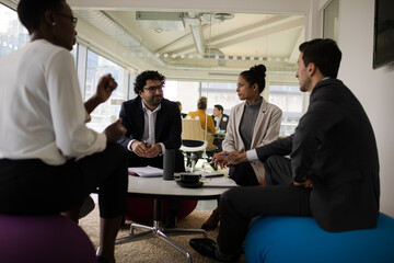 Fototapeta premium Business people discussing paperwork in relax zone